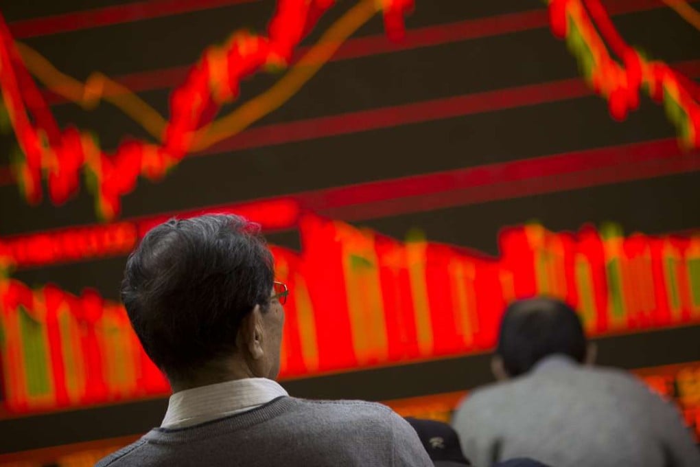 A Chinese investor monitors stock prices at a brokerage house in Beijing. Photo: AFP