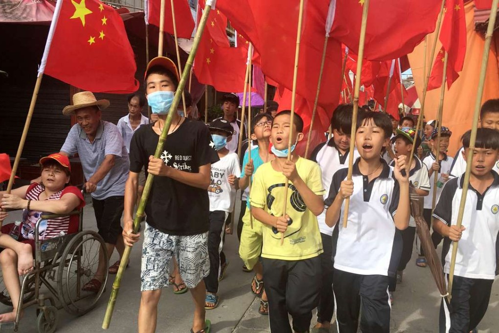 Villagers including schoolchildren took part in a protest in June, demanding the release of their village chief Lin Zuluan, in Wukan. Photo: Reuters