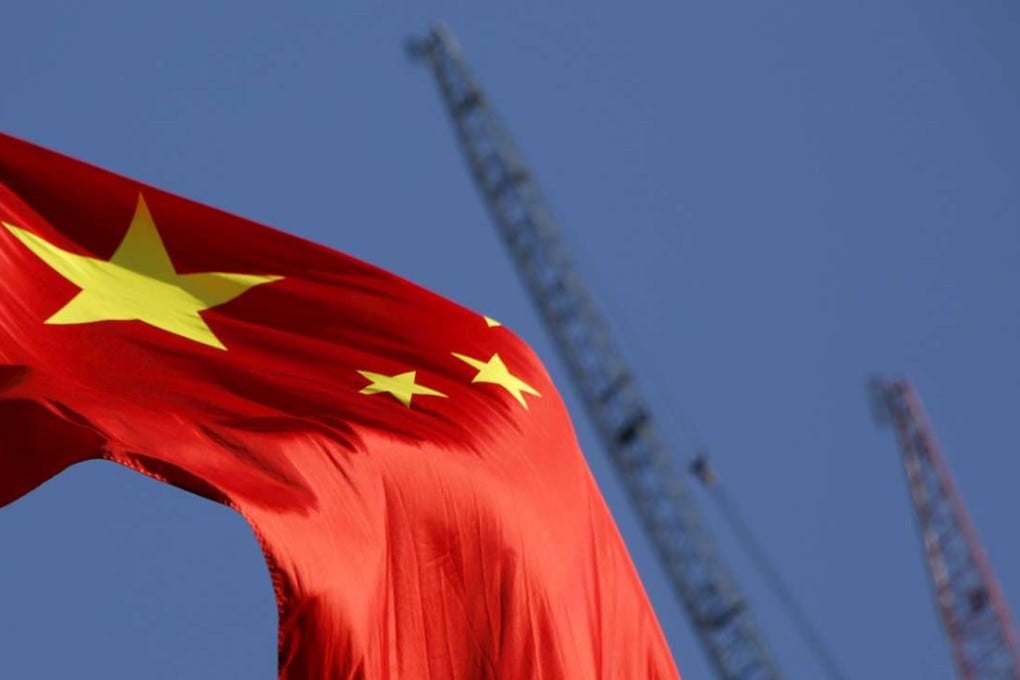 China’s national flag flies near a construction site in Beijing. Photo: Reuters