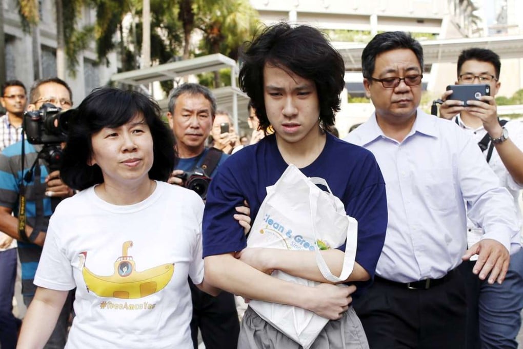 Teen blogger Amos Yee leaves with his parents after his sentencing from the State Court in Singapore. Photo: Reuters