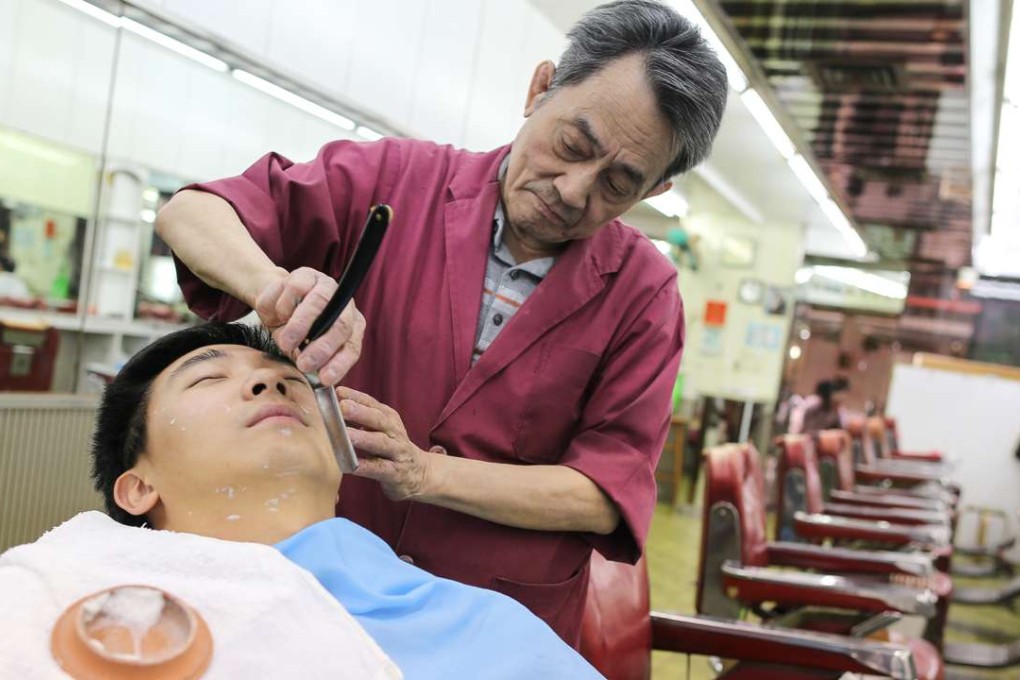 Ko Tak-tin shaves a customer at Kiu Kwun Barber Shop. Photo: Dickson Lee