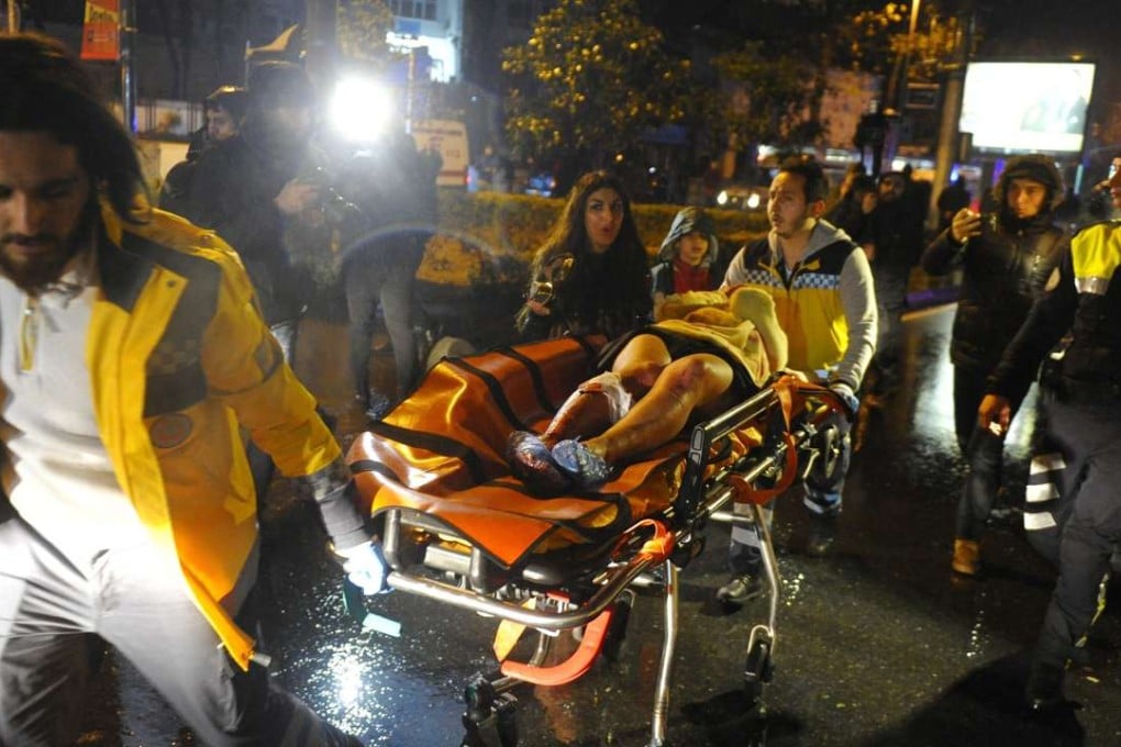 Medics carry a wounded victim on a stretcher to an ambulance after a gun attack on Reina, a popular nightclub in Istanbul. Photo: EPA