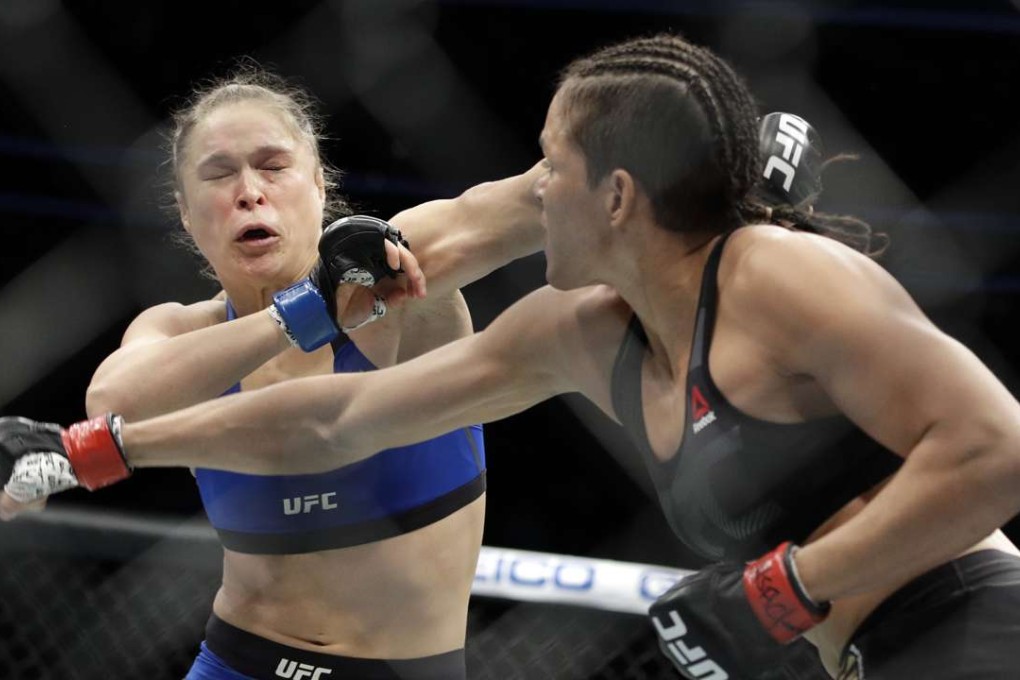 Amanda Nunes, right, throws a punch at Ronda Rousey in the first round of their women's bantamweight championship mixed martial arts bout at UFC 207, Friday, Dec. 30, 2016, in Las Vegas. Nunes won the fight after it was stopped in the first round. (AP Photo/John Locher)
