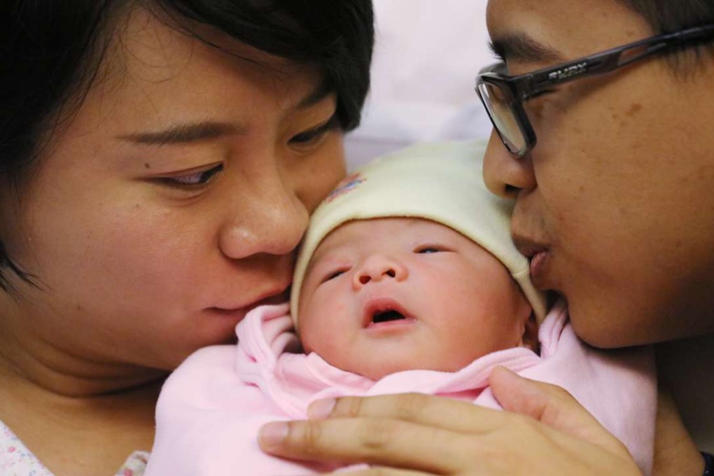 Tsang Sze-wing (left) and Sun Chi-fai with their newborn son at Hong Kong Baptist Hospital in Kowloon Tong. Photo: Felix Wong