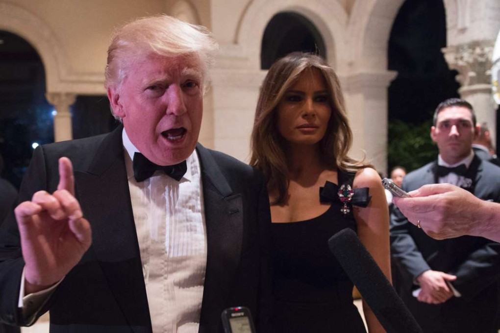 US President-elect Donald Trump answers questions from reporters accompanied by wife Melania for a New Year's Eve party at Mar-a-Lago in Palm Beach, Florida. Photo: AFP