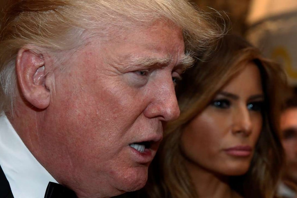 US president-elect Donald Trump talks to reporters as he and his wife Melania Trump arrive for a New Year's Eve celebration with members and guests at the Mar-a-lago Club in Palm Beach, Florida. Photo: Reuters
