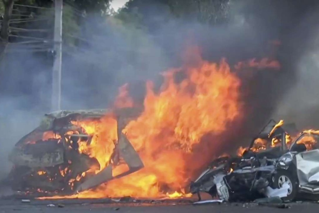 Screengrab from a video shows two vehicles burning after they collided on a highway east of Bangkok, Thailand. Photo: AP