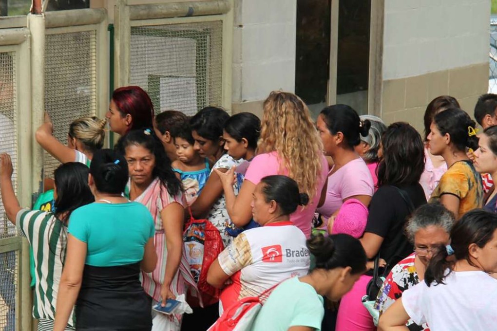 Relatives of inmates ask for information at the main gate of the Anisio Jobim Penitentiary Complex after a riot left at least 60 people killed and several injured, in Manaus, Amazonia state, Brazil. Photo: AFP
