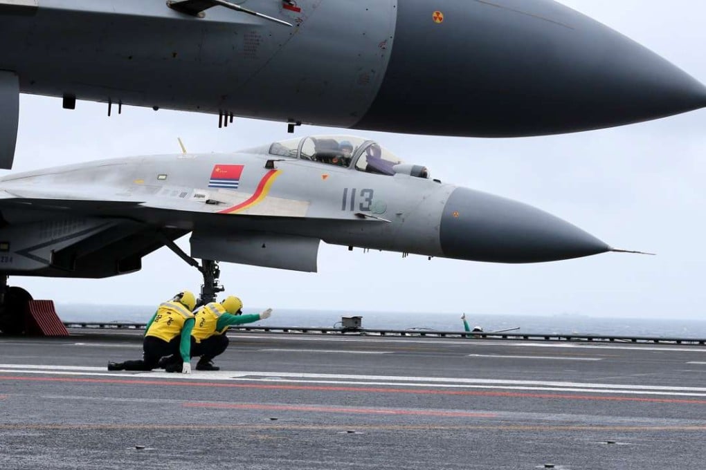 A J-15 jet fighter prepares to take off from the deck of the Liaoning, China's first aircraft carrier, during a drill in the South China Sea on Monday. Photo: CNS
