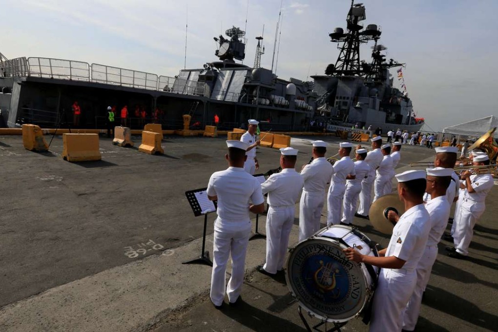 Philippine Navy band members play music to welcome the Russian Navy vessel Admiral Tributs, a large anti-submarine ship, as it docks at the south harbour port area in Metro Manila on January 3, 2017. Photo: Reuters