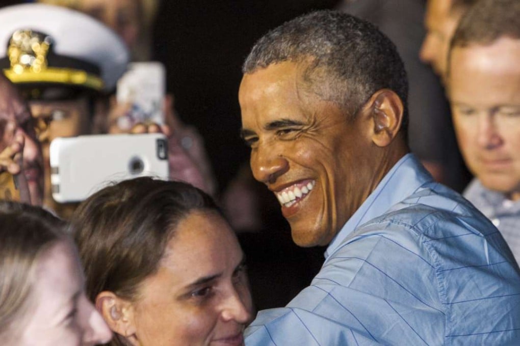 US President Barack Obama greets people as he leaves Joint Base Pearl Harbor-Hickam, adjacent to Honolulu, Hawaii, en route to Washington on Sunday, January 1, 2017, after his annual family vacation on the island of Oahu. Photo: AP