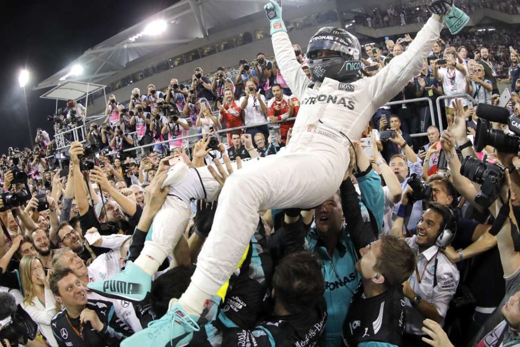 German Formula One driver Nico Rosberg celebrates with his team after winning the Formula One World Championship. Photo: EPA
