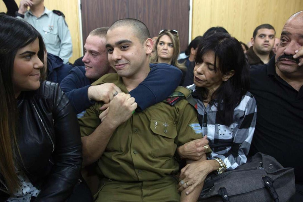 Israeli soldier Elor Azaria with his parents as he awaits for the verdict in his case at the military court in Tel Aviv. Photo: AFP