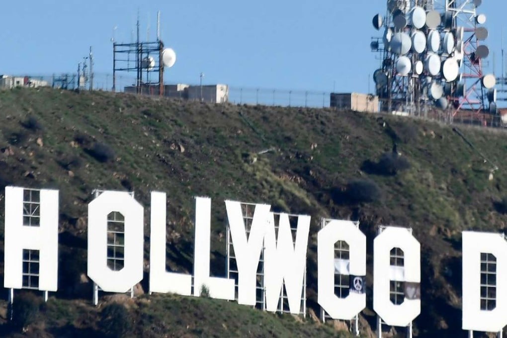 The famous Hollywood sign reads "Hollyweed" after it was vandalized, January 1, 2017. Police said unidentified thrill-seekers had climbed up and arranged tarps over the two letter "O's" to make them look like "E's." Photo: AFP