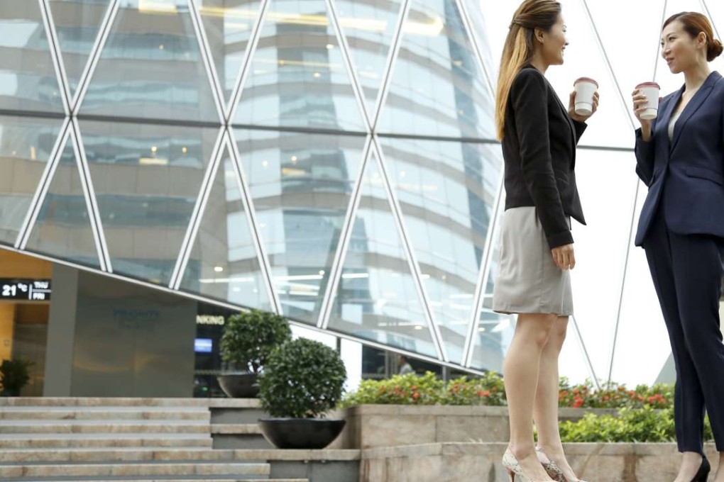 Two young millennnial businesswomen talking and drinking coffee outside an office tower. Research now shows the group is far more likely to invest ethically than their older peers. Photo: Getty Images/iStockphoto/Thinkstock