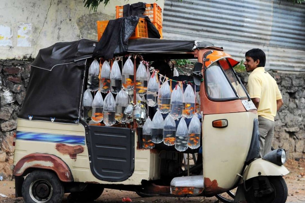 A vendor in Colombo, Sri Lanka, sells fish from his bajaj. Picture: AFP