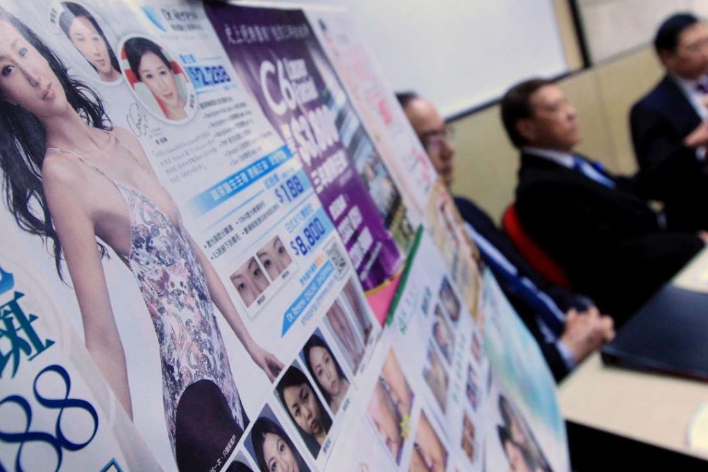 Posters of beauty centres are displayed at a press conference in 2012 to push for a risk classification of services. Photo: Jonathan Wong