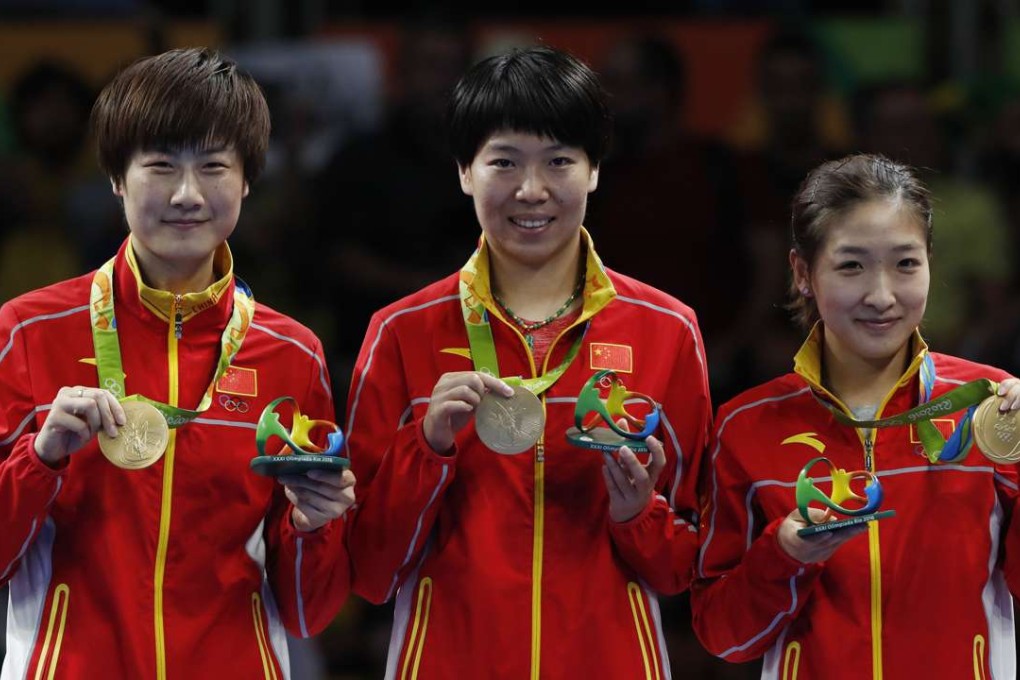 China’s Ding Ning (L), Li Xiaoxia (C) and Liu Shiwen receive the gold medal after the women’s team final at the 2016 Rio Olympic Games. Photo: Xinhua