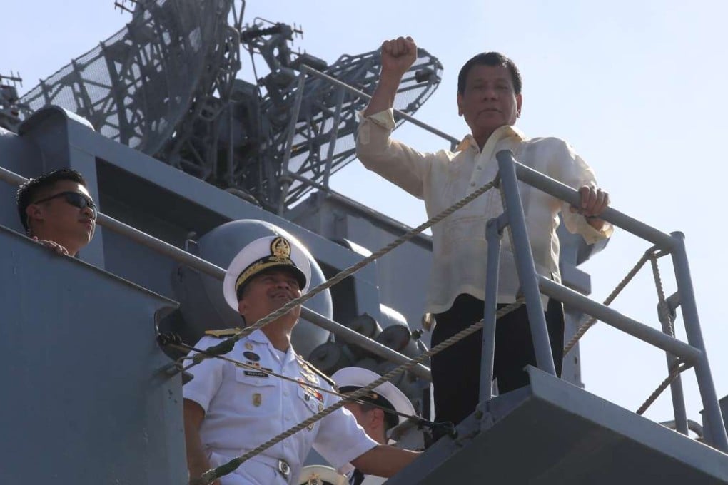 Philippine President Rodrigo Duterte clenches his fist during his tour at the Russian Navy vessel Admiral Tributs. Photo: Reuters
