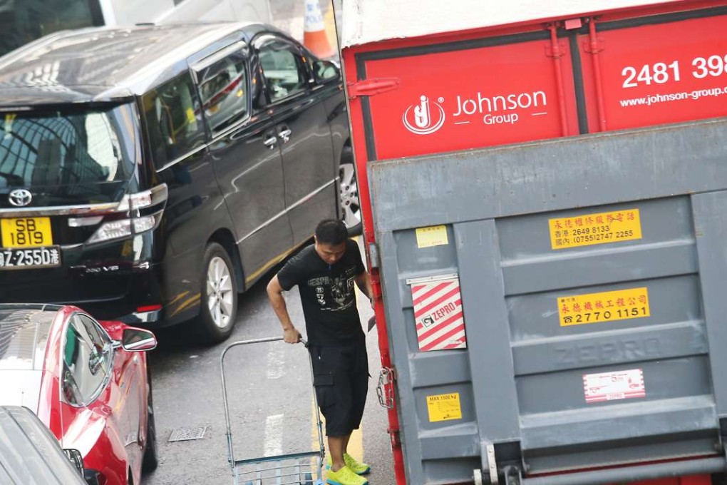 Illegally parked cars mean delivery vehicles have to occupy traffic lanes. Photo: David Wong