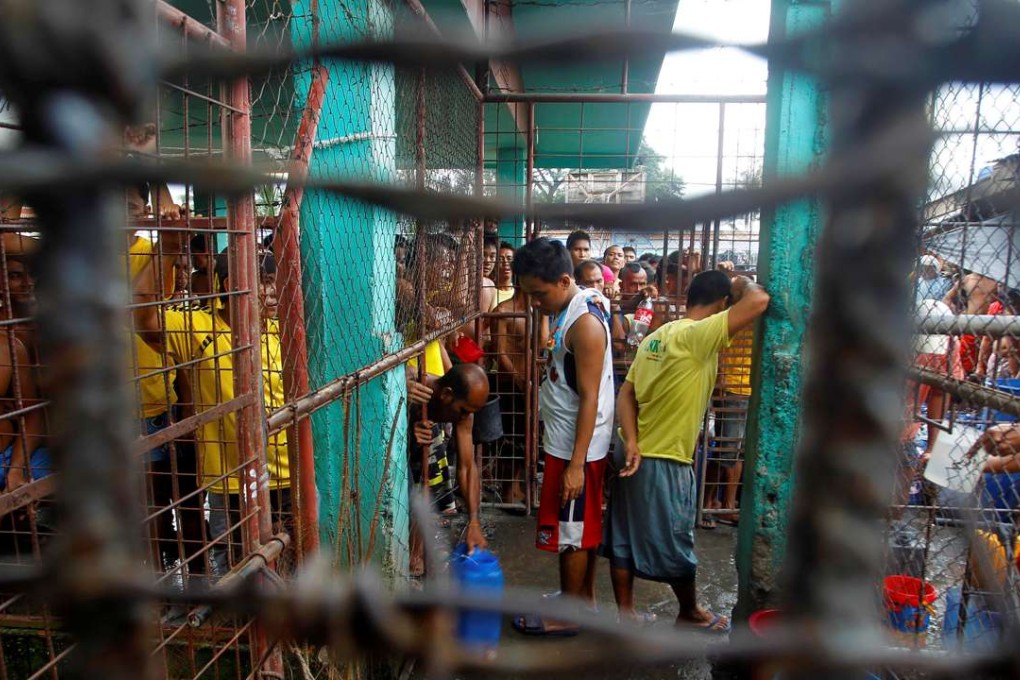 Inmates gather inside the Kidapawan prison following the escape of more than 150 inmates. Photo: Reuters