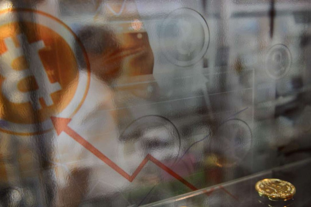 A man walks past a display cabinet containing models of Bitcoins in Hong Kong. Bitcoin neared its all-time high on January 5, 2017 with the surging digital currency tipped to become a new safe haven asset as the world grapples with growing economic uncertainty. Photo: AFP