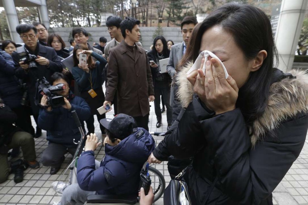 A family member of one victim weeps during a press conference against court's sentence. Photo: AP