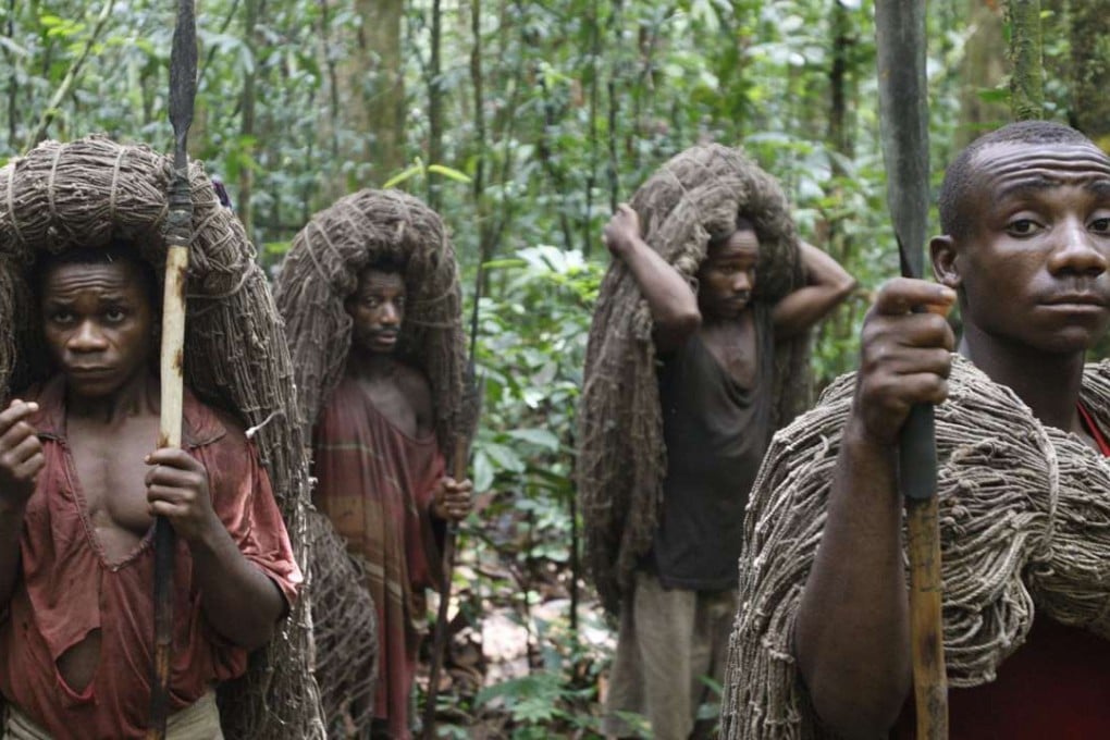 A file photo shows Pygmy men with their hunting nets and spears as they await the start of the day's hunt, in the Okapi Wildlife Reserve outside the town of Epulu, Congo. Ethnic clashes over traditional Pygmy food sources have been on the rise. Photo: AP