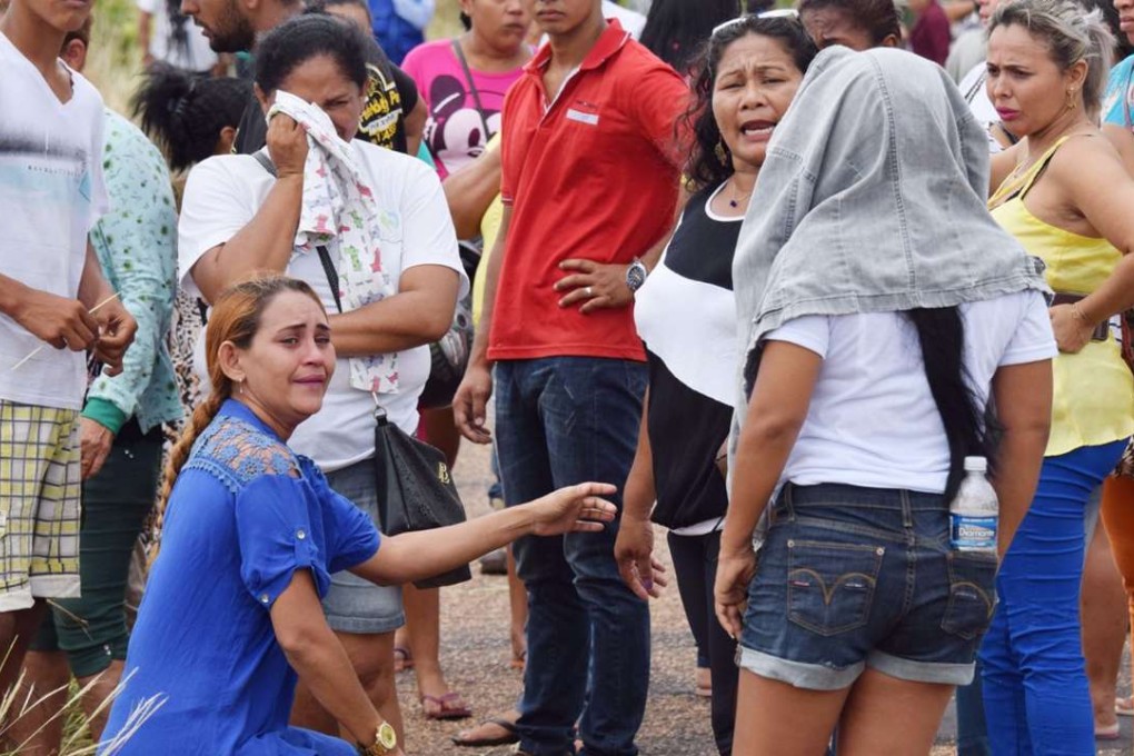 Relatives wait for information on the welfare of inmates, outside the Agricultural Penitentiary of Monte Cristo. Photo: AP