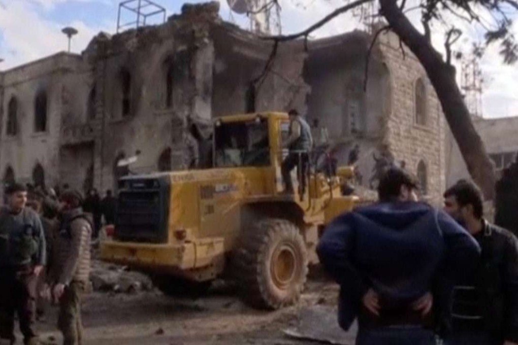 Civilians gather in front of a building damaged by the truck bomb. Photo: Reuters