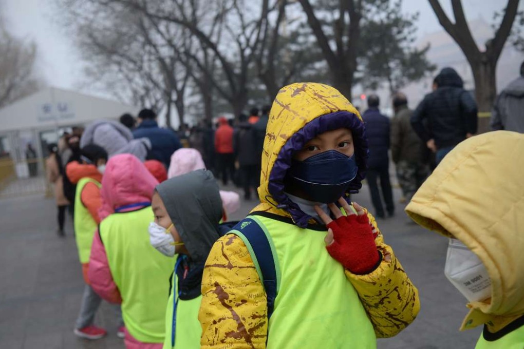 School pupils wearing masks wait to undergo security checks as they visit the National Museum in Beijing. Photo: AFP