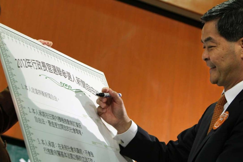 Then chief executive hopeful Leung Chun-ying prepares to sign a card that reads: “I will defend press freedom; I will push for legislations on freedom of information during my term and create a more open society”, at a candidates’ seminar organised by the Hong Kong Journalists Association in Wan Chai on February 17, 2012. Leung was elected Hong Kong’s leader the following month. Photo: Felix Wong