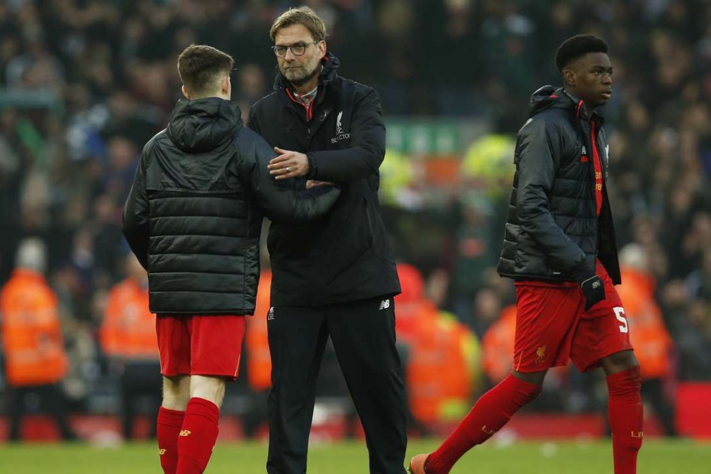 Liverpool manager Juergen Klopp shakes hands with youngster Ben Woodburn after the match. Photo: Reuters