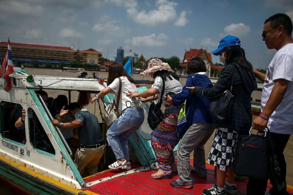 Chinese tourists board a sightseeing boat on the Chao Phraya River in Bangkok. Photo: Reuters