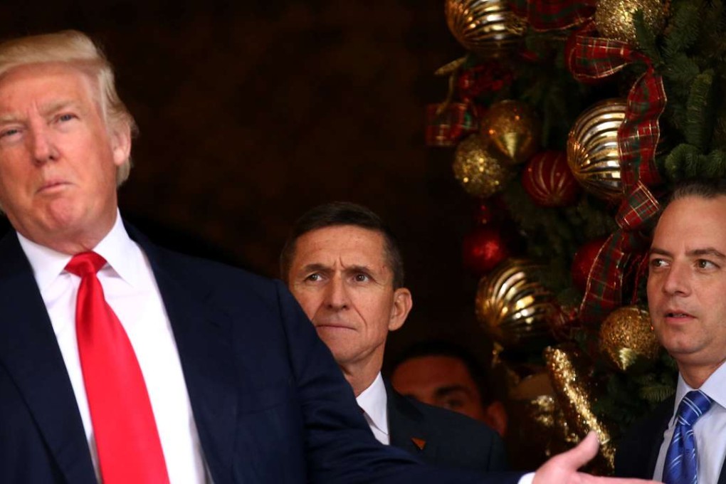 Incoming White House Chief of Staff Reince Priebus (right) and U.S. Army Lieutenant General Michael Flynn (centre) look at US President-elect Donald Trump as he talks with the media at Mar-a-Lago estate in Florida last month. Photo: Reuters