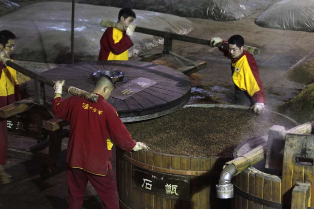 Workers produce baijiu or white liquor at state-owned Luzhou Laojiao in Luzhou, Sichuan. Demand for expensive Chinese grain liquor has begun to recover after three years of declines. Photo: Dickson Lee
