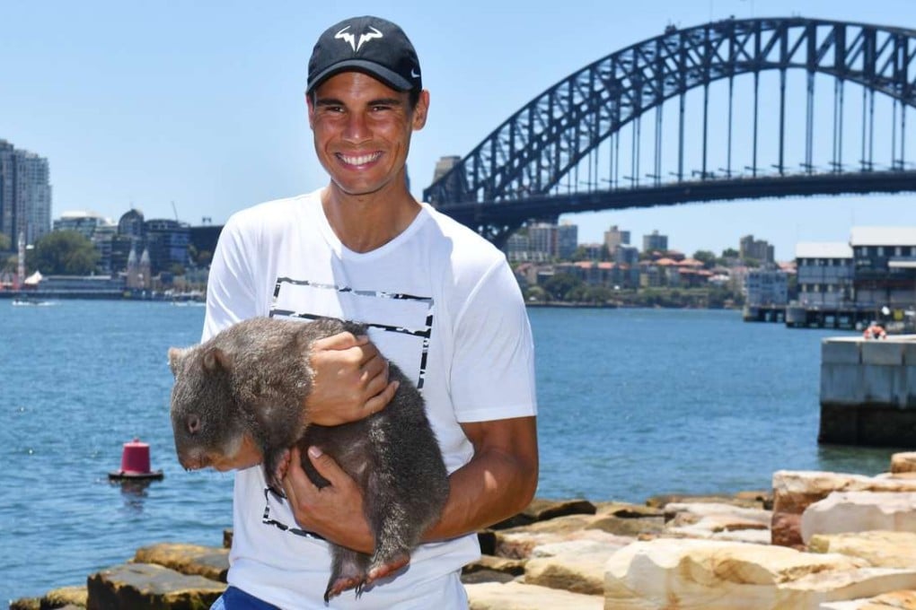 Rafael Nadal holds a wombat named in Sydney. Photo: EPA