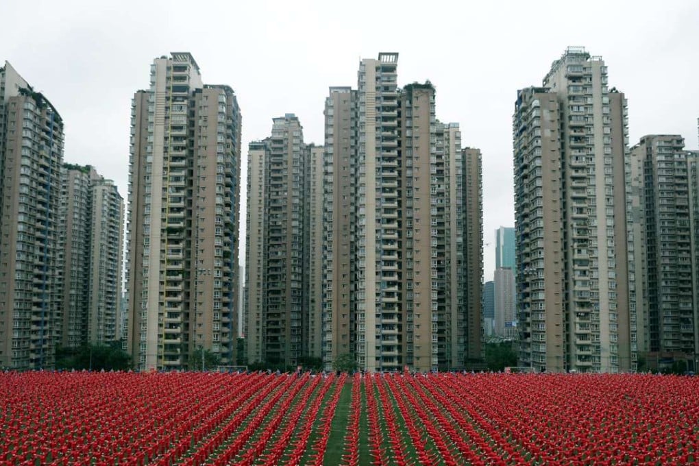 People dance at a football court to challenge the Guinness World Record of the most people dancing square dance at the same time, in Chongqing. Photo: Reuters