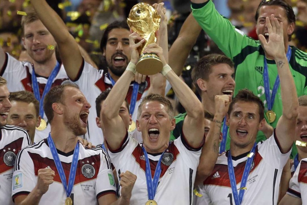 Germany's Bastian Schweinsteiger holds up the World Cup trophy as the team celebrates their 1-0 victory over Argentina in the 2014 final. Photo: AP