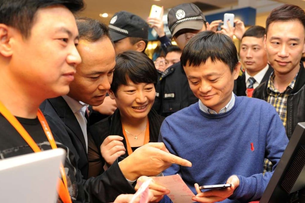 Alibaba’s Jack Ma Yun (second, right) is accompanied by Intime Retail Group chairman Shen Guojun (second left) on November 16, 2013. Photo: Xinhua