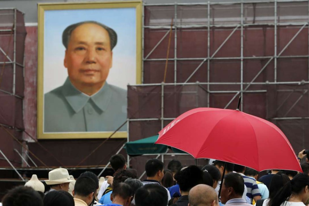 Mao Zedong’s portrait hangs above tourists visiting Tiananmen in Beijing. Photo: Xinhua