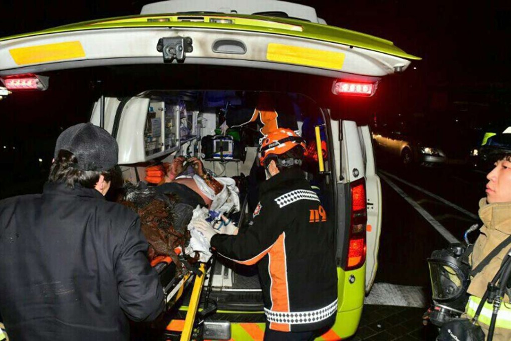 The injured Buddhist monk who set himself on fire is put into an ambulance in Seoul, South Korea. He has since died of his injuries. Photo: AP
