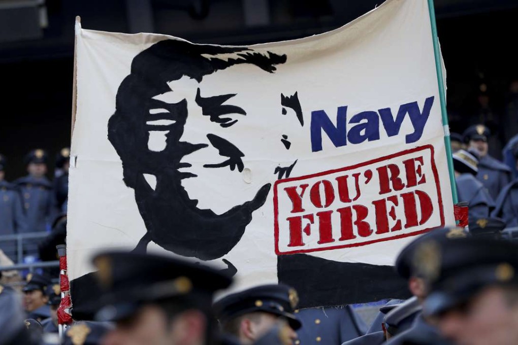 Cadets from the US Military Academy fly a banner depicting Donald Trump prior to the game between the Navy Midshipmen and the Army Black Nights at M&T Bank Stadium in Baltimore, Maryland. Photo: AFP