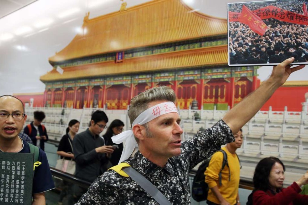 Protesters remember the Tiananmen Square crackdown in front of a backdrop of Beijing’s Forbidden City between the Hong Kong and Central MTR stations. Photo: Sam Tsang