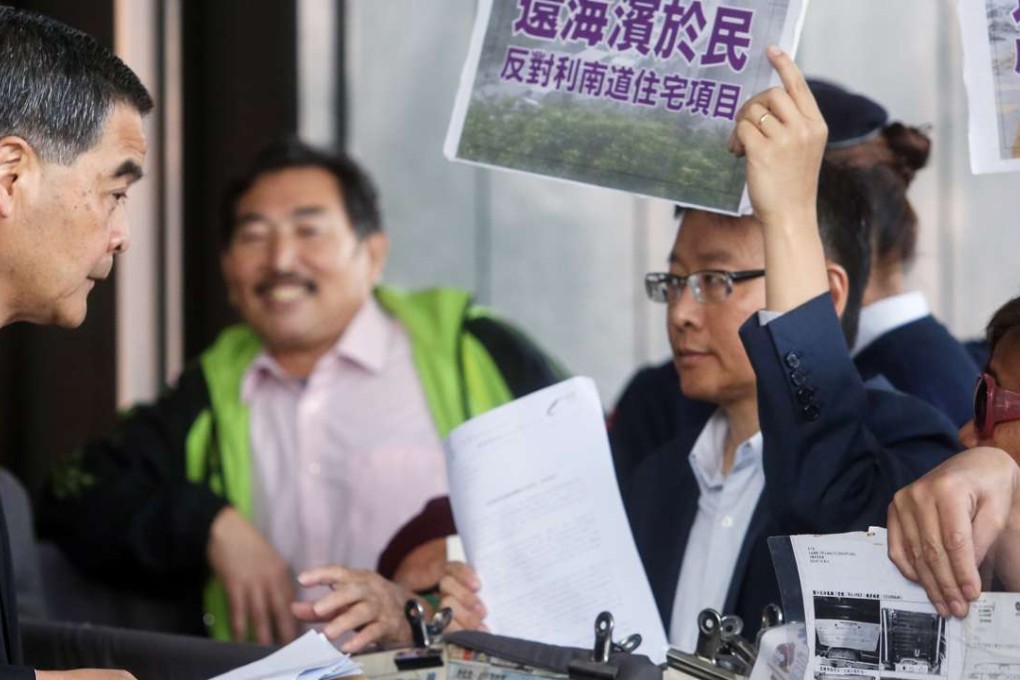 Former legislator professor Chan Ka-lok (right) protests against Leung (left) over plans to develop private residential housing. Photo: Sam Tsang