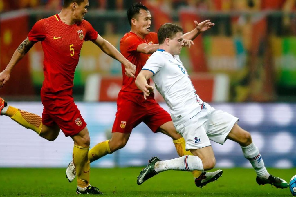 Bjorn Bergmann Sigurdarson (right) of Iceland tries to keep possession against China’s Fan Xiaodong and Yang Shanping China during the China Cup in Nanning. Photo: AFP