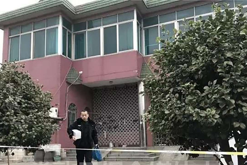 A police officer removes evidence from the family home. Photo: Handout
