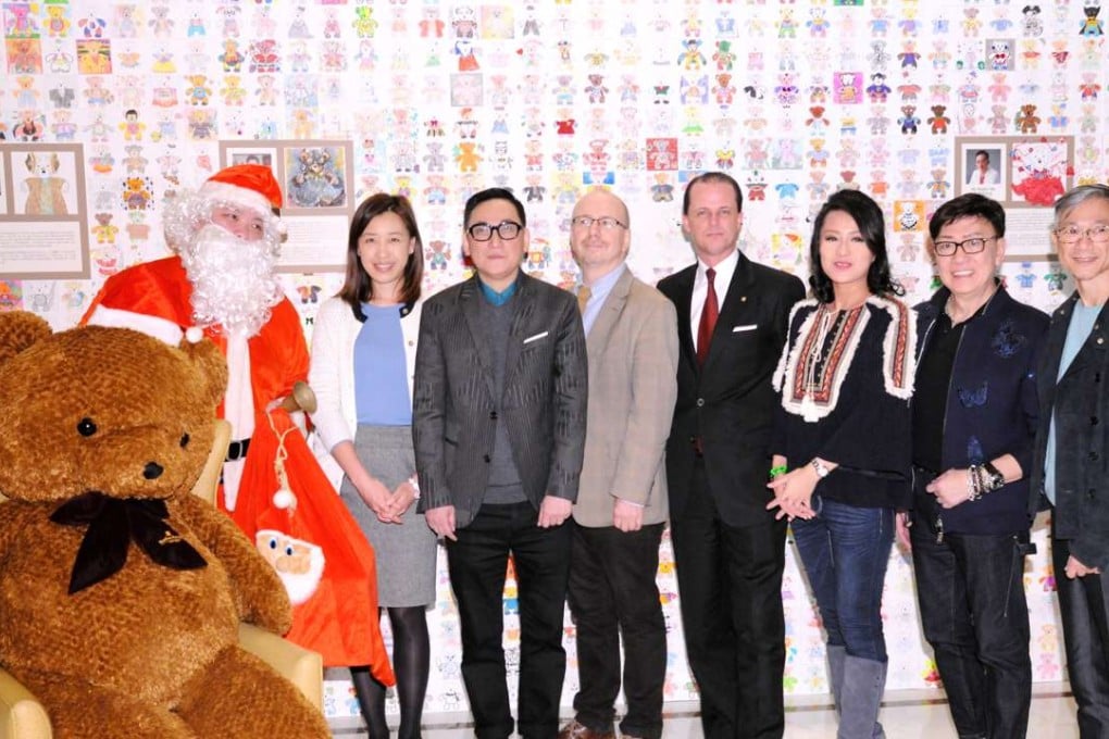 Ellen Yeung (second from left) of the South China Morning Post, fashion designer Walter Ma, Hugh Chiverton of RTHK, Kowloon Shangri-La resident manager Julian Wipper, actress Skye Chan and fashion designers Benny Yeung and Allan Chiu at the Shangri-La Hotel in Tsim Sha Tsui East, where designs of teddy bears submitted by participants have been showcased on a wall. Photo: Handout