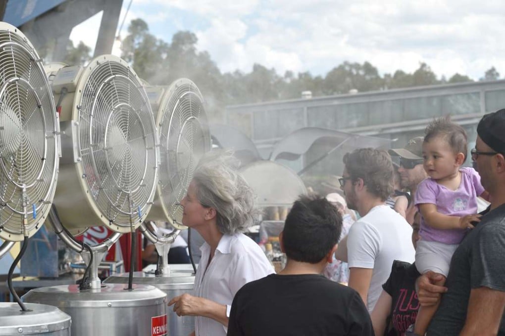 People cool down in front of fans at the Sydney International tennis tournament in Sydney. Photo: AFP