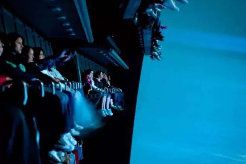 Visitors seated while on the Soaring Over the Horizon ride at Shanghai Disneyland shortly before it broke down. Photo: Leo Hou